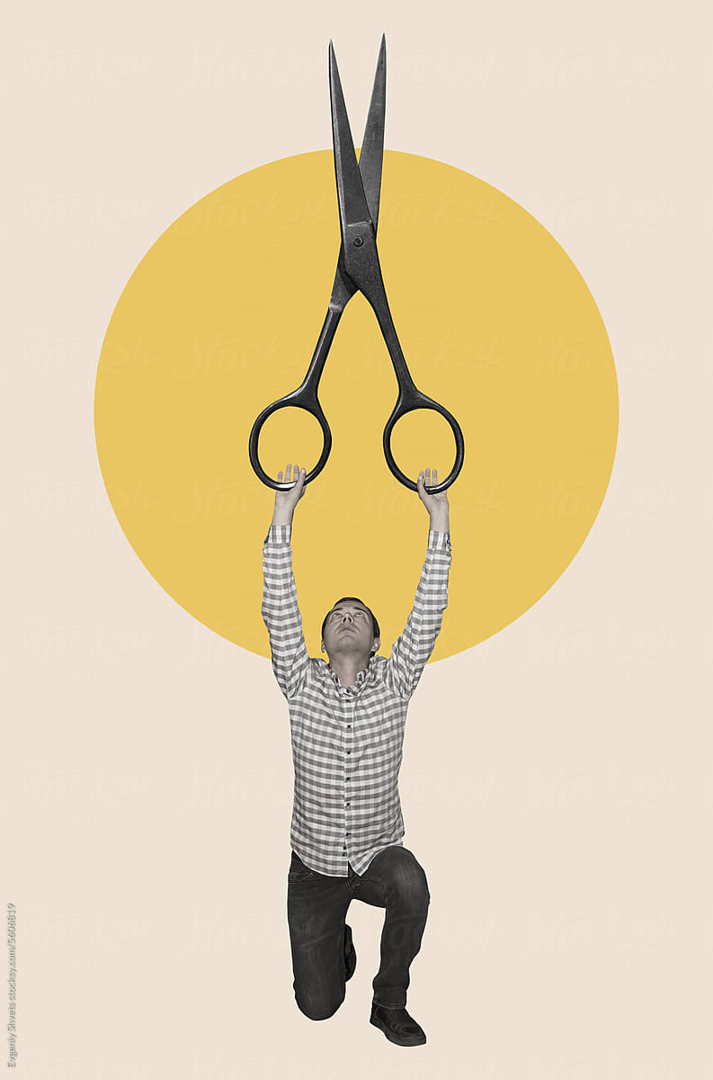 A Man Holding Giant Scissors by Stocksy Contributor Evgeniy