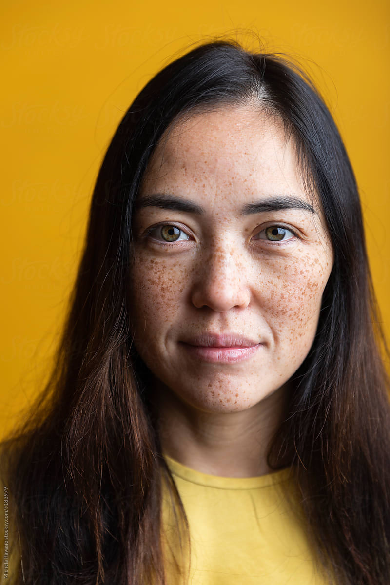 Portrait of beautiful Asian woman with freckles