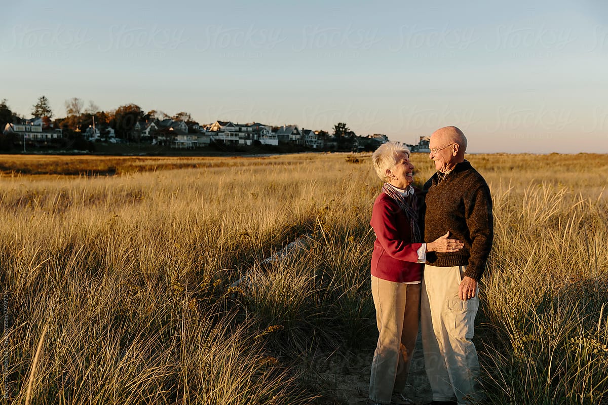 Happy Senior Couple Hugging And Smiling Outdoors Modern Love By Stocksy Contributor Raymond 