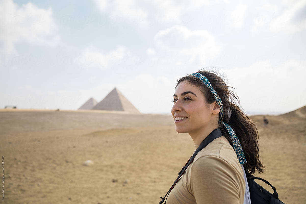 Close-up of a smiling woman visiting the pyramids of Egypt