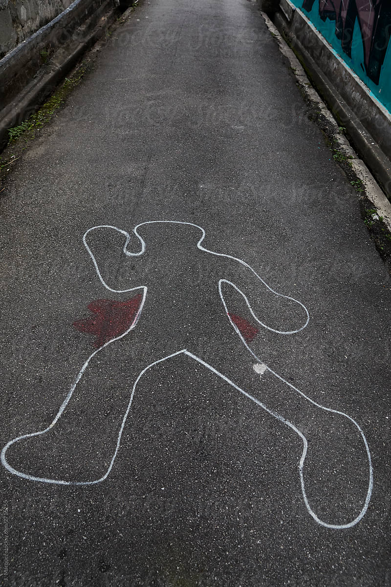 Outlined silhouette of victim lying down with red spot beside on asphalt road