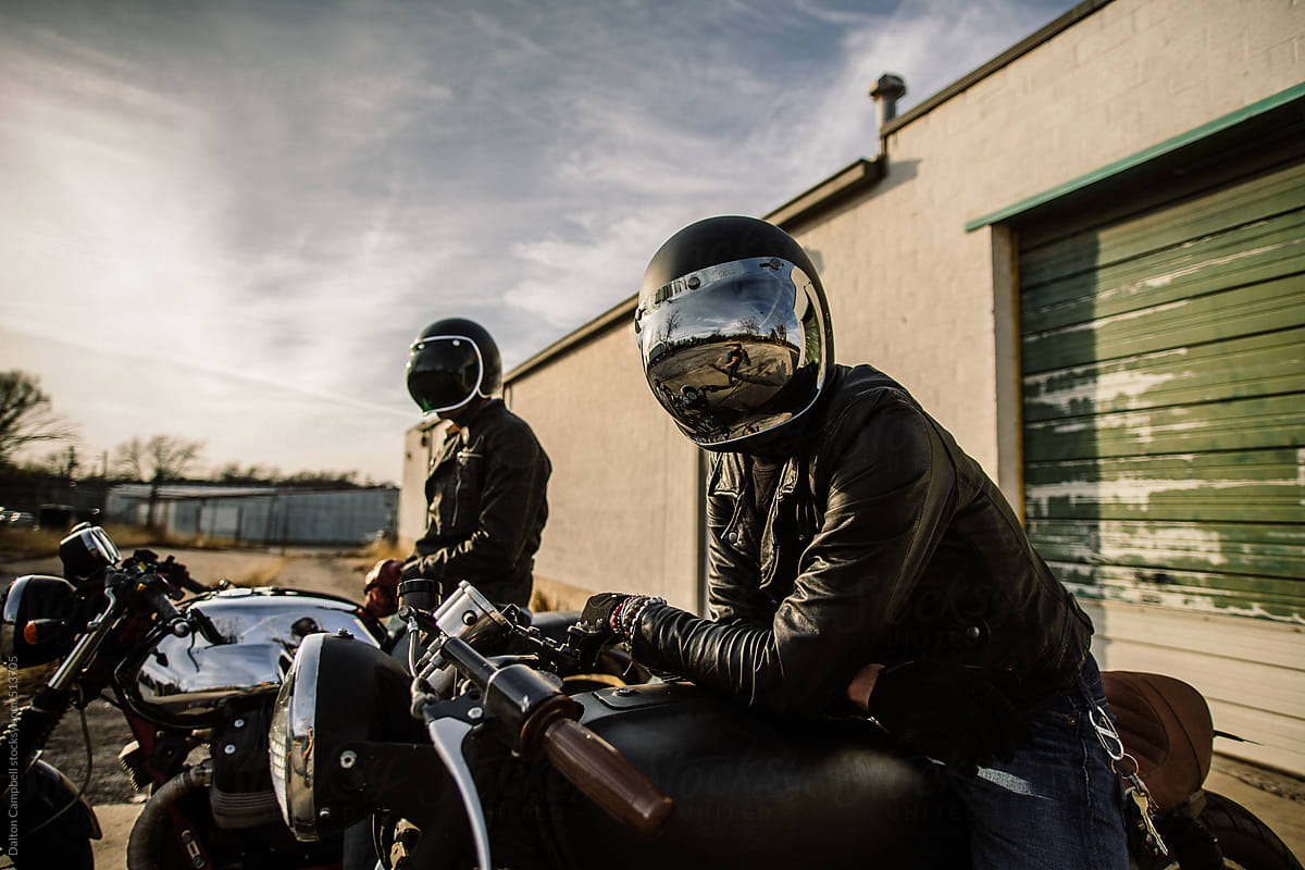 Friends about to ride motorcycles together.