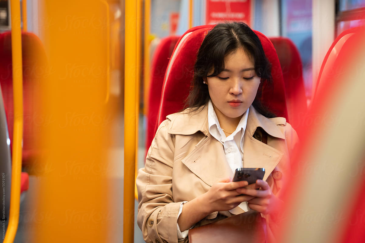 Woman Using Smartphone In Public Transport