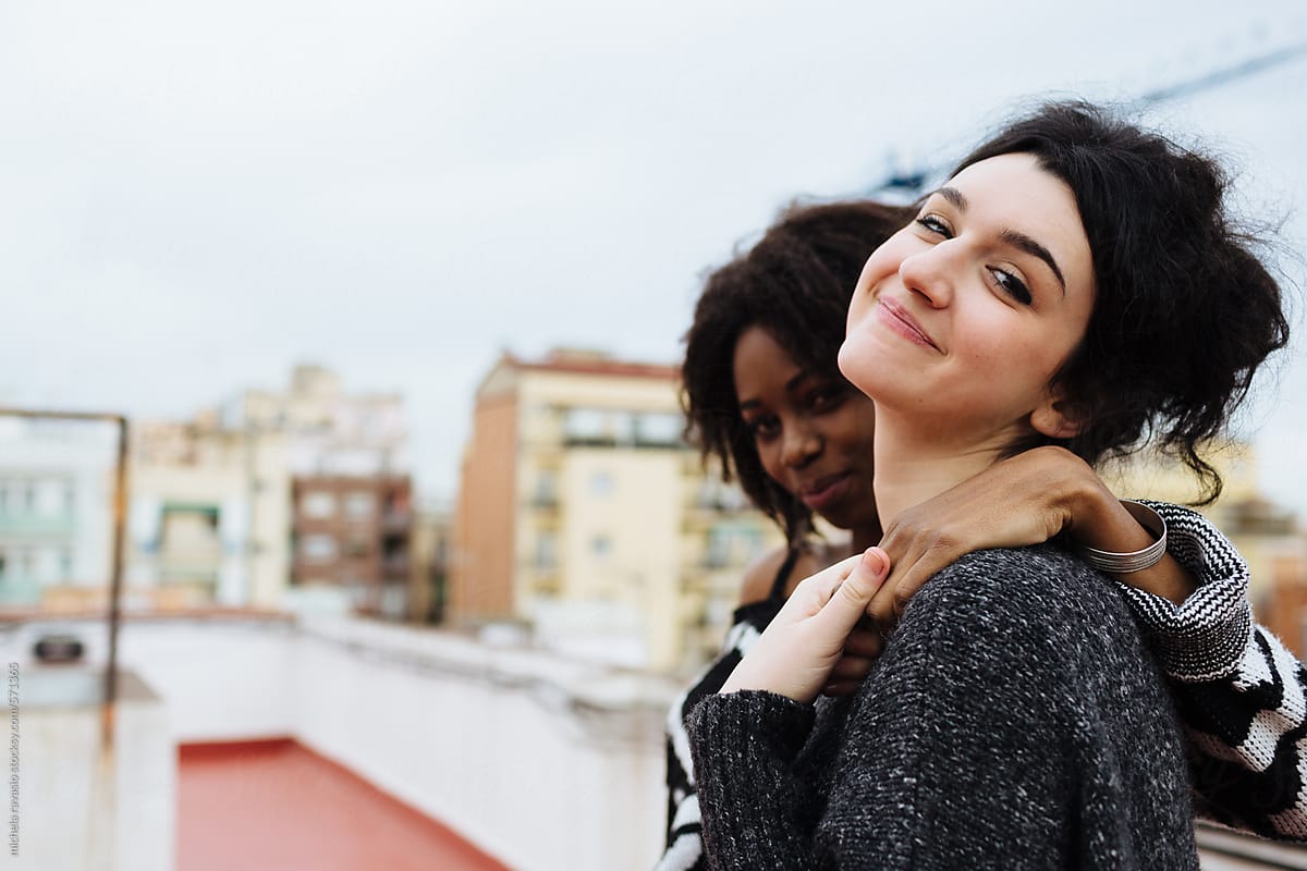 Two Female Friends Embraced Looking At Camera By Stocksy Contributor Michela Ravasio Stocksy 