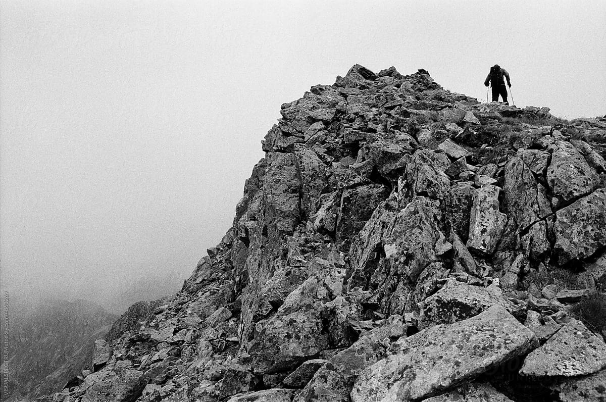 Hiker Ascending Rocky Peak