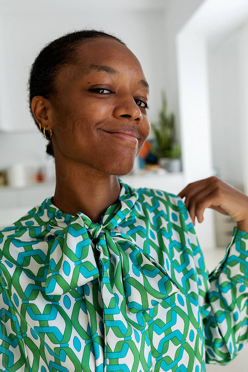 African woman in vintage blouse at home