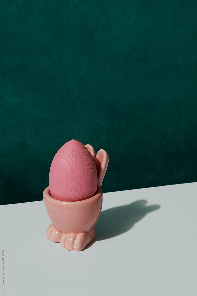 pink wooden egg in a pink easter egg cup
