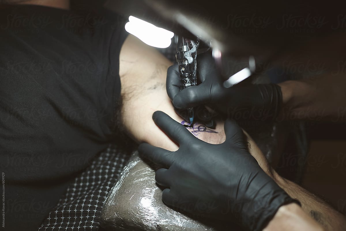Close up on Tattoo Artist making a tattoo on the arm