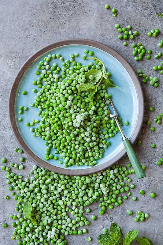 Frozen peas and mint on a blue plate