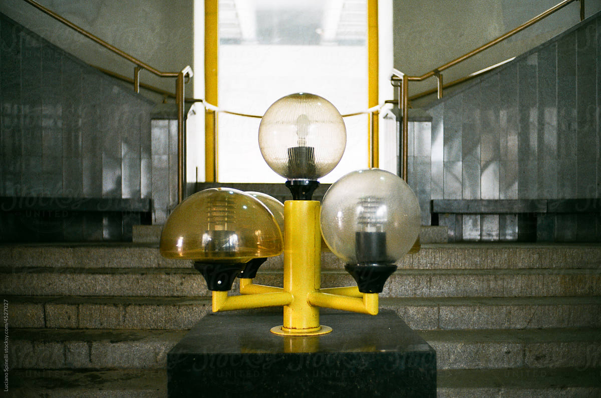 Modernist entrance hall with three rounded lamps and stairs