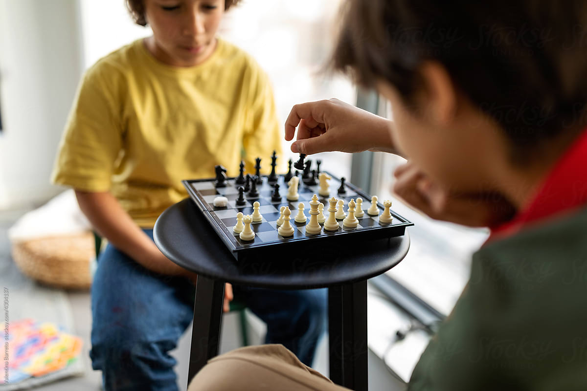 Kids playing chess indoor