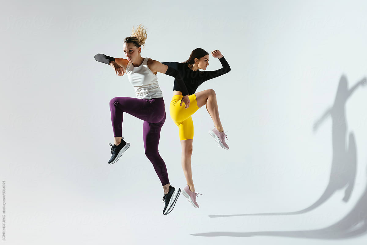Active women jumping in studio