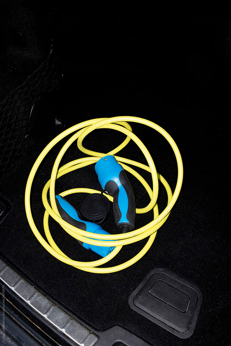 Photo of modern charger / wire of electric car with hard flashlight