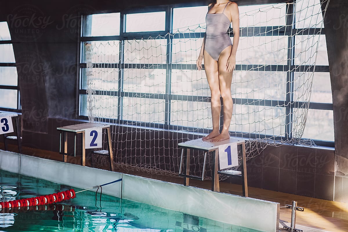 Woman Swimmer Standing on Diving Board