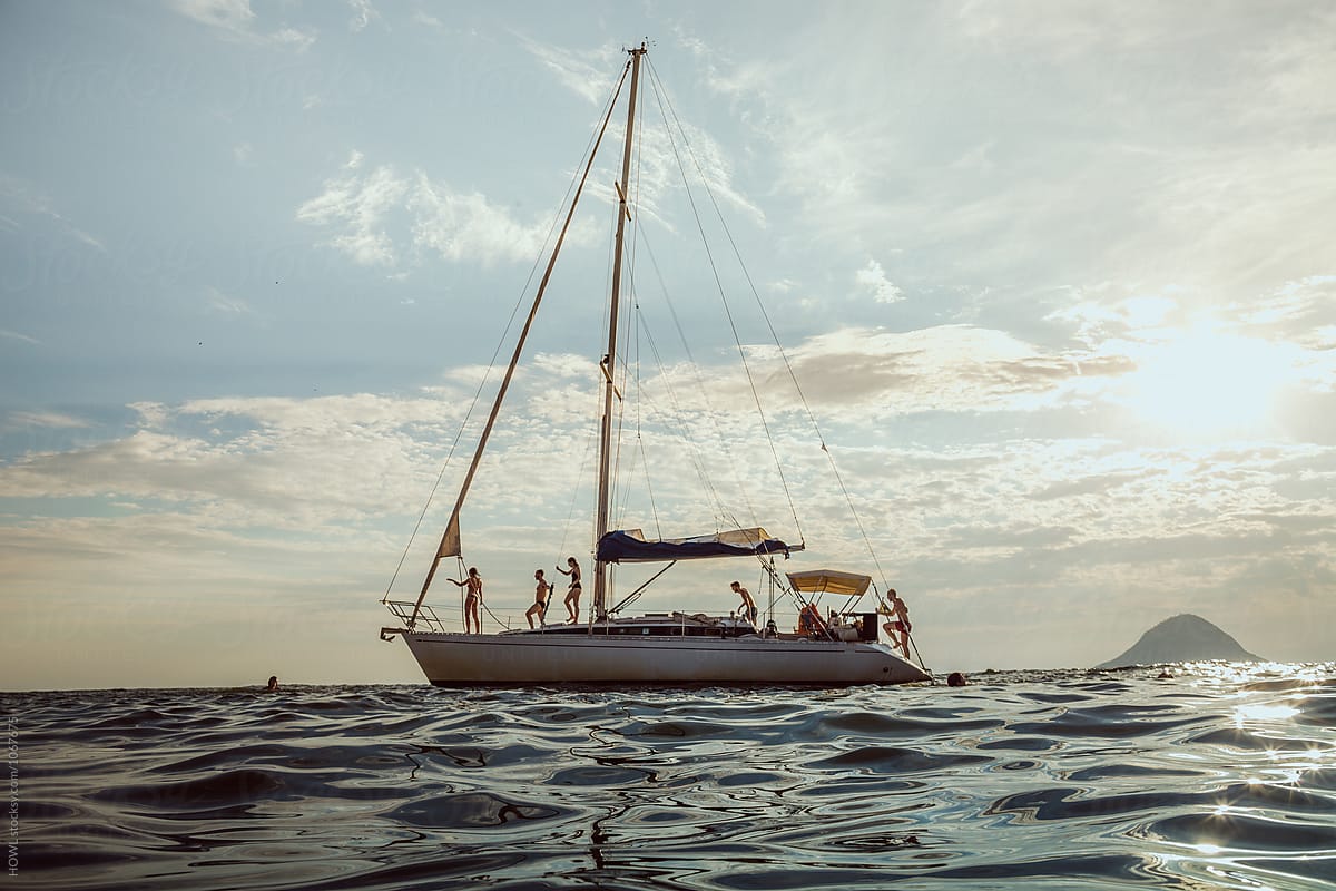 A group of young tourists lounge on a sailboat in Brazil