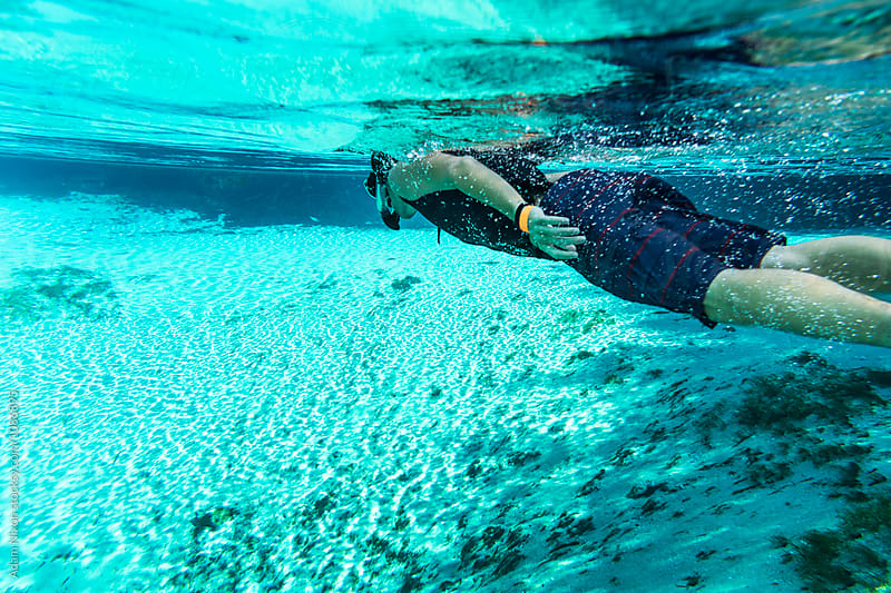 A teenager snorkeling in a fresh water spring in Florida