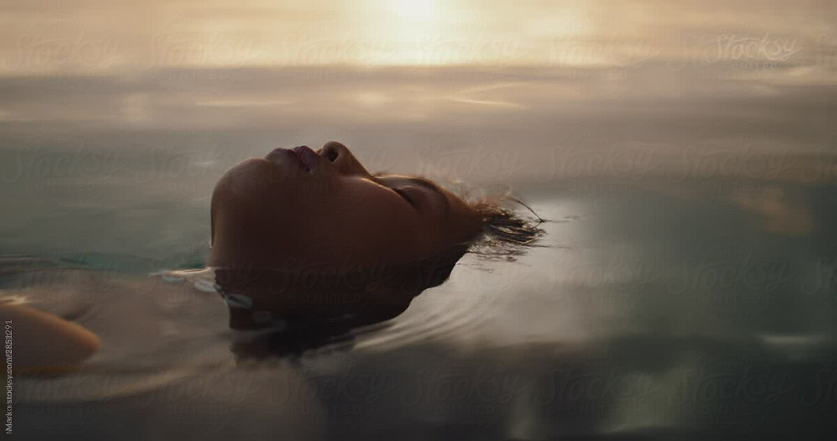 Woman Floating In Water Relaxing Sunset By Stocksy Contributor Marko Stocksy