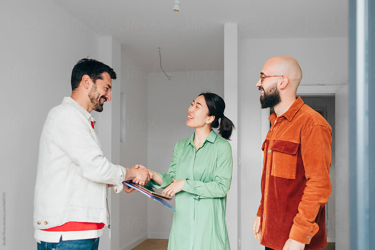 Real Estate Agent Shaking Hands with Clients