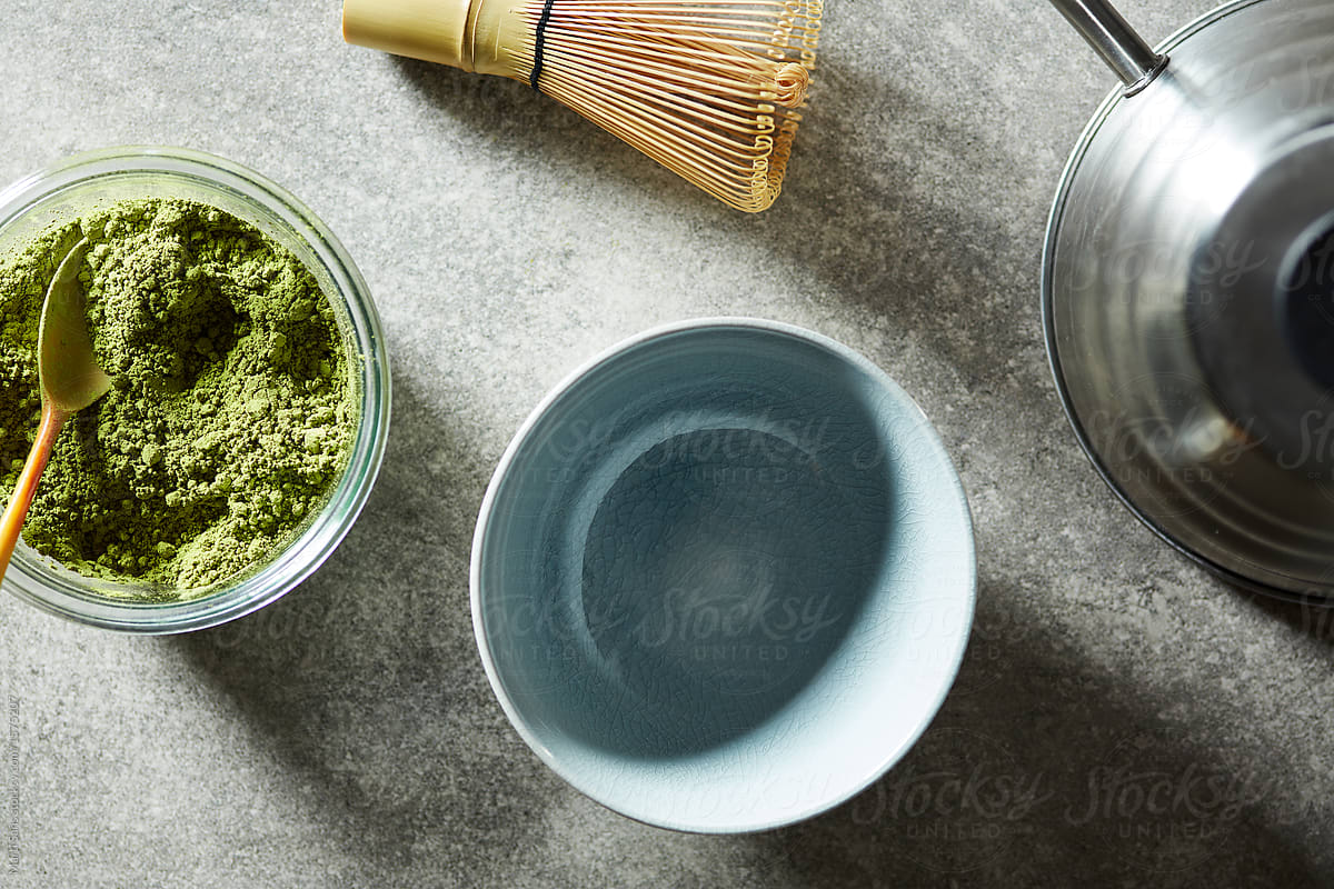 Green matcha tea and utensils for preparing tea.