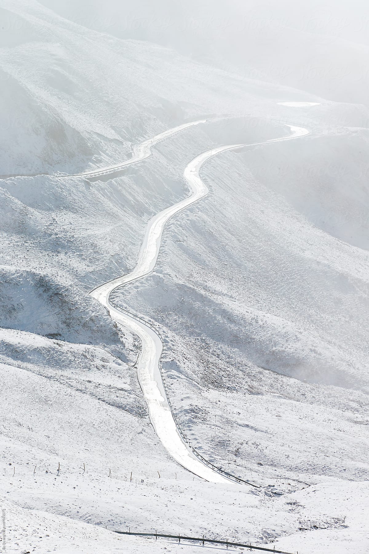 road go around the snowy mountain