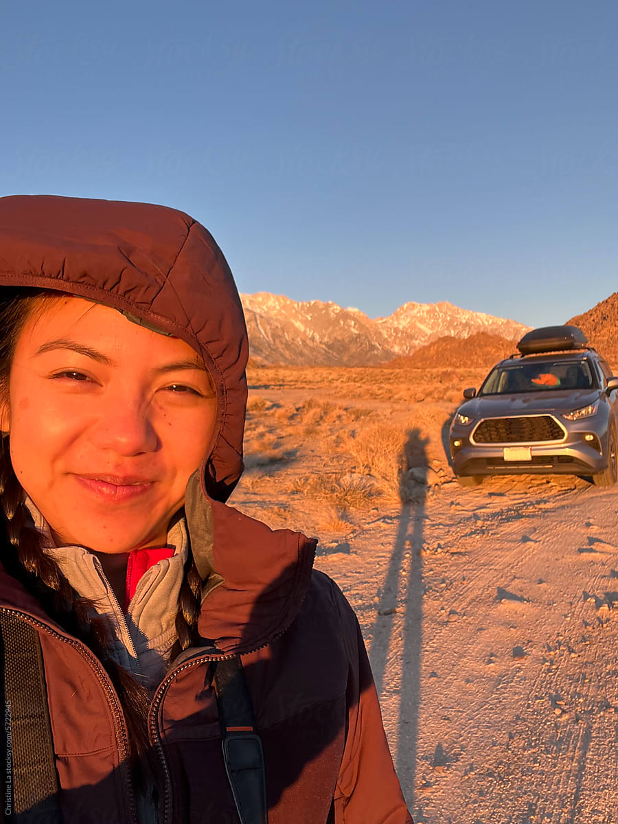 Selfie with car on road trip at sunrise