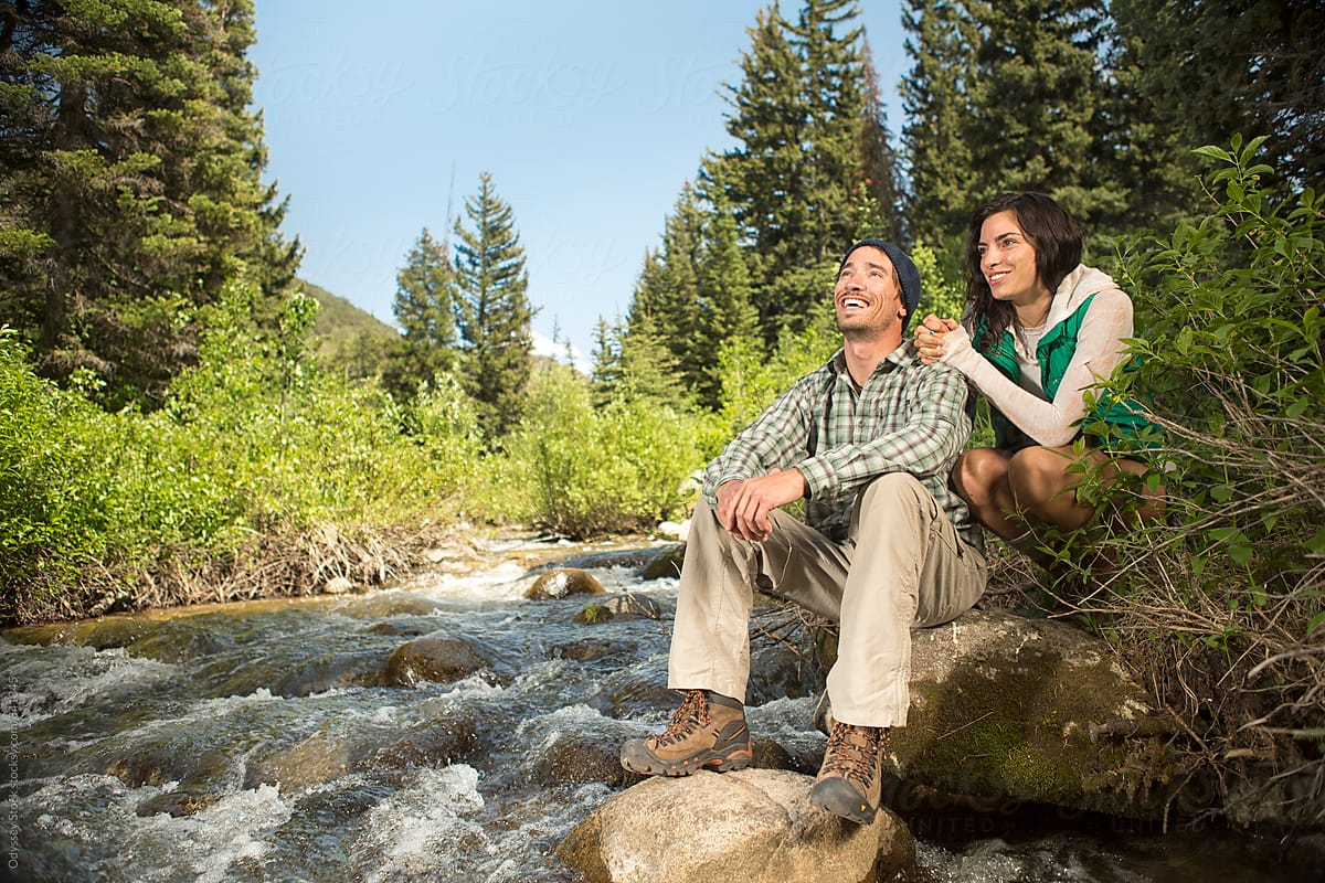 Hiking Couple Relaxing by River