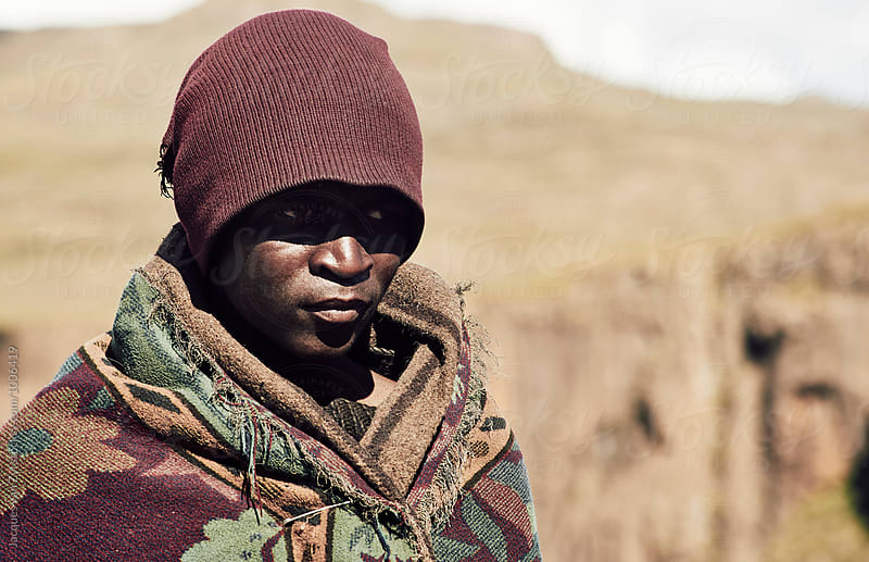 Portrait of a black Basotho shepherd wrapped in a traditional blanket.