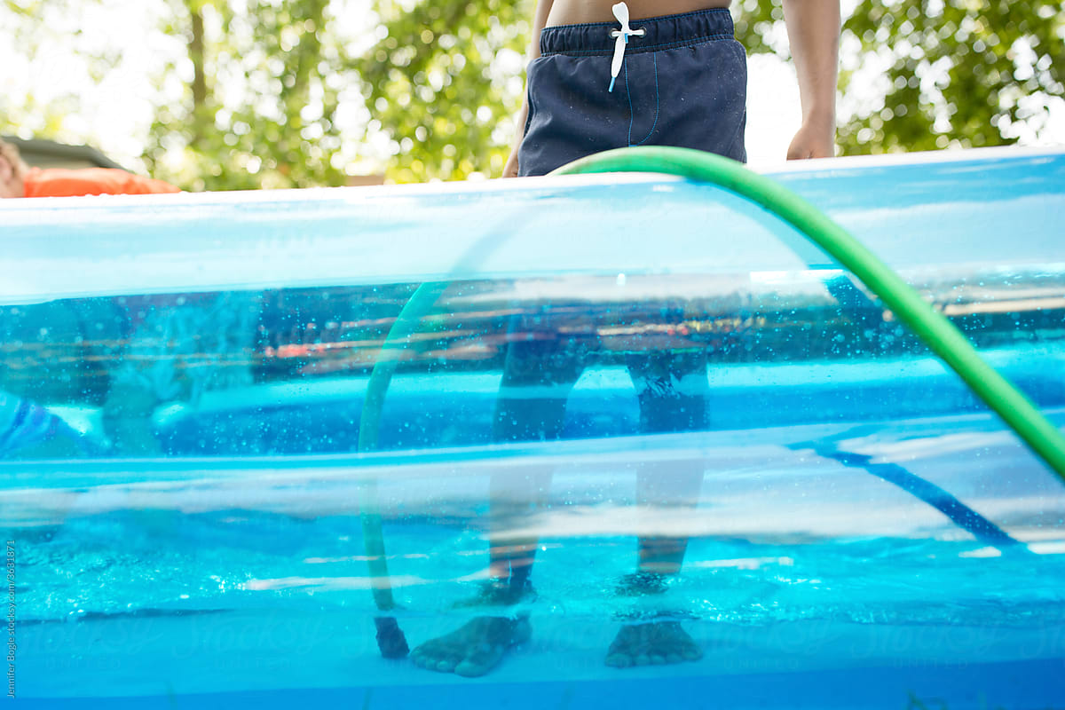 Feet of boy in pool as it fills with water