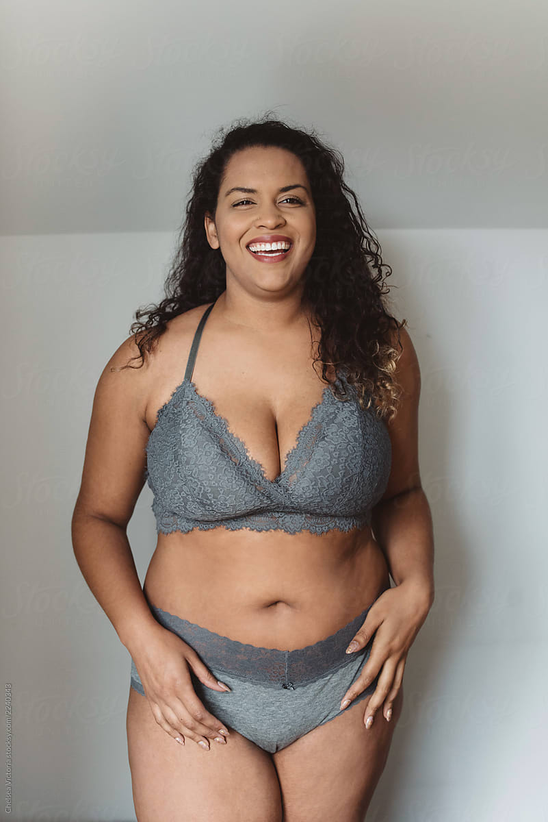 A Beautiful Plus Size Woman In Her Twenties Lounging At Home In A Bra 7013