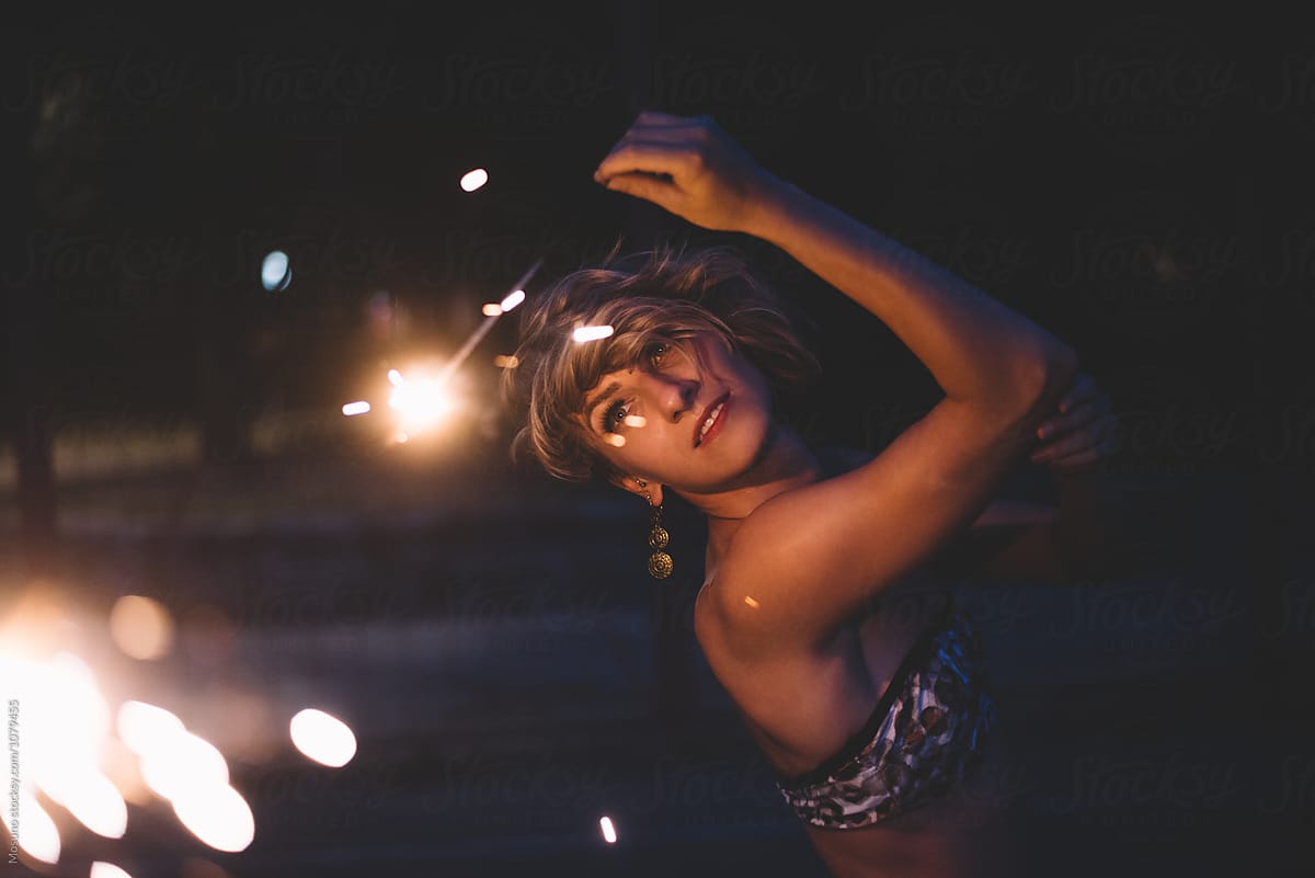 Woman Holding A Sparkler By Night By Stocksy Contributor Mosuno Stocksy