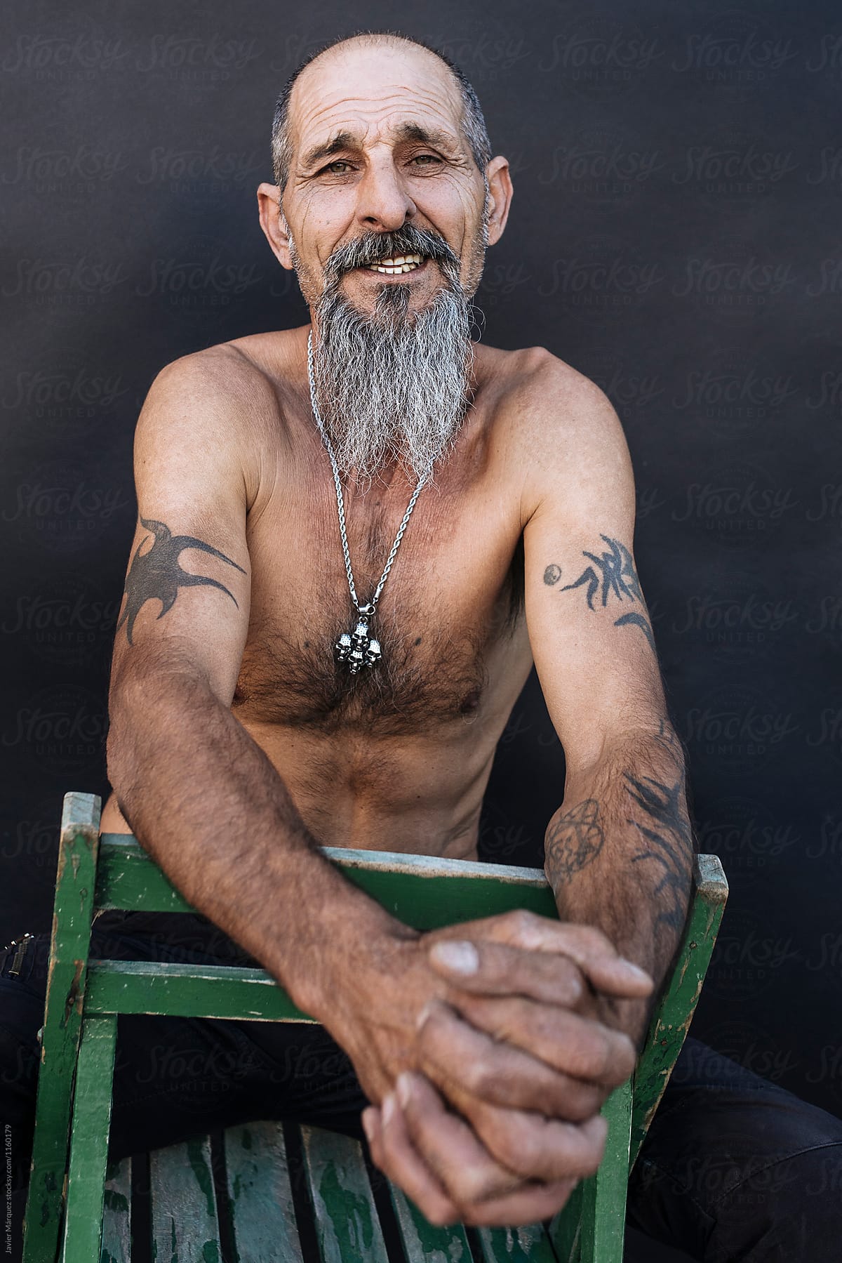 Portrait of a tattooed aged man