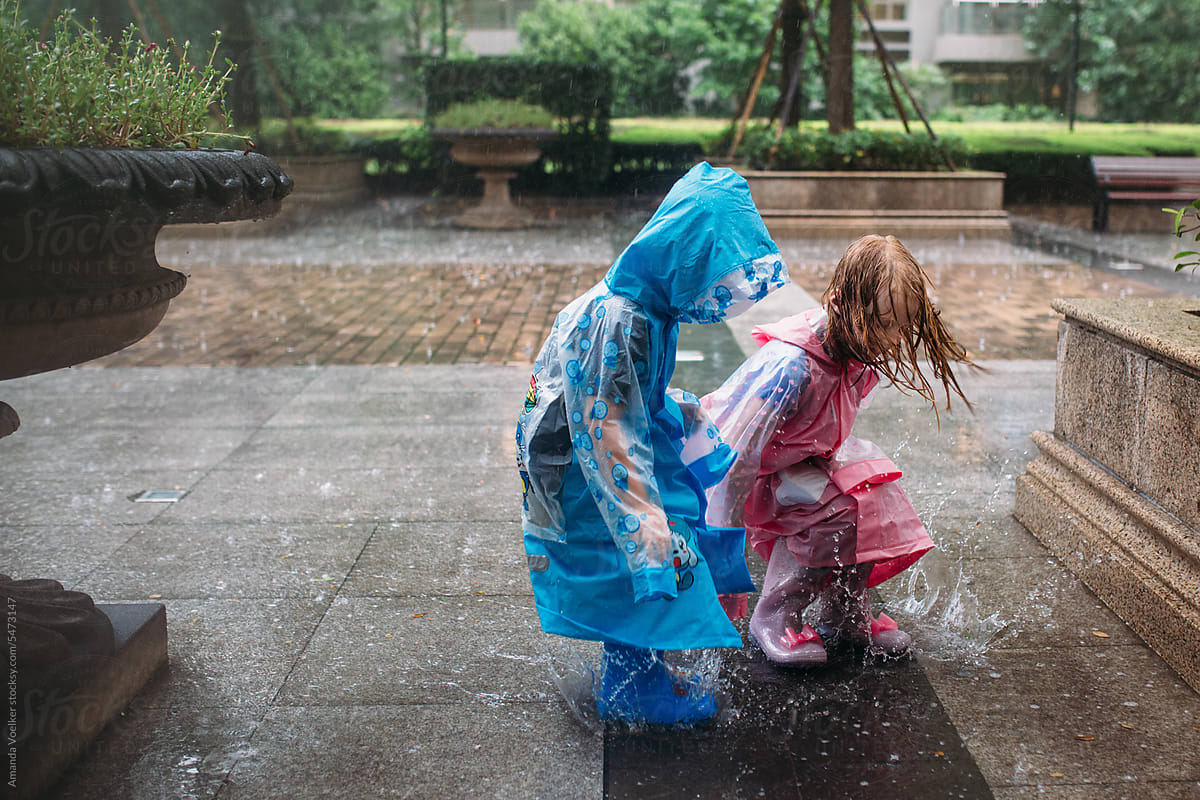 Two kids playing in the rain