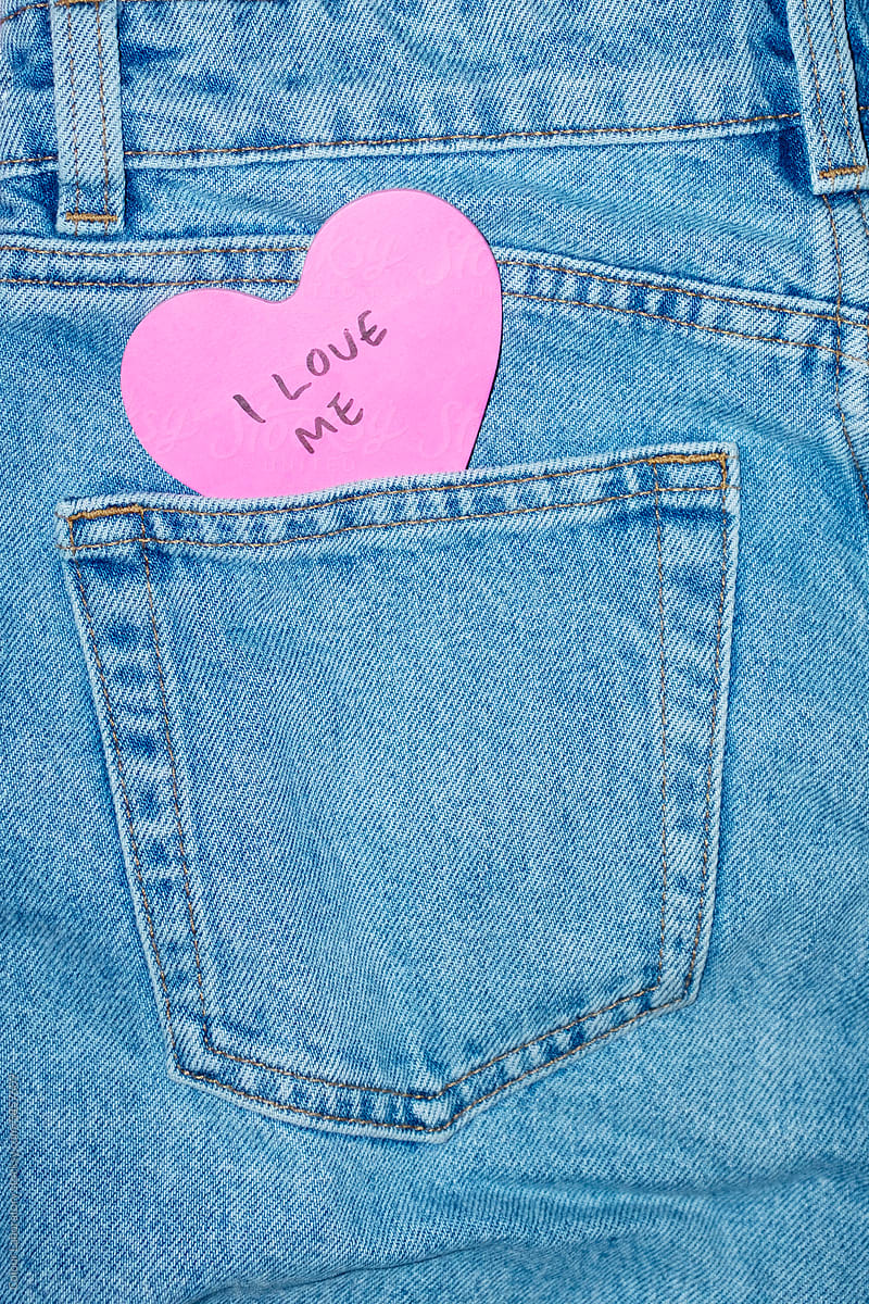 Classic blue jeans with heart-shaped post it note and \