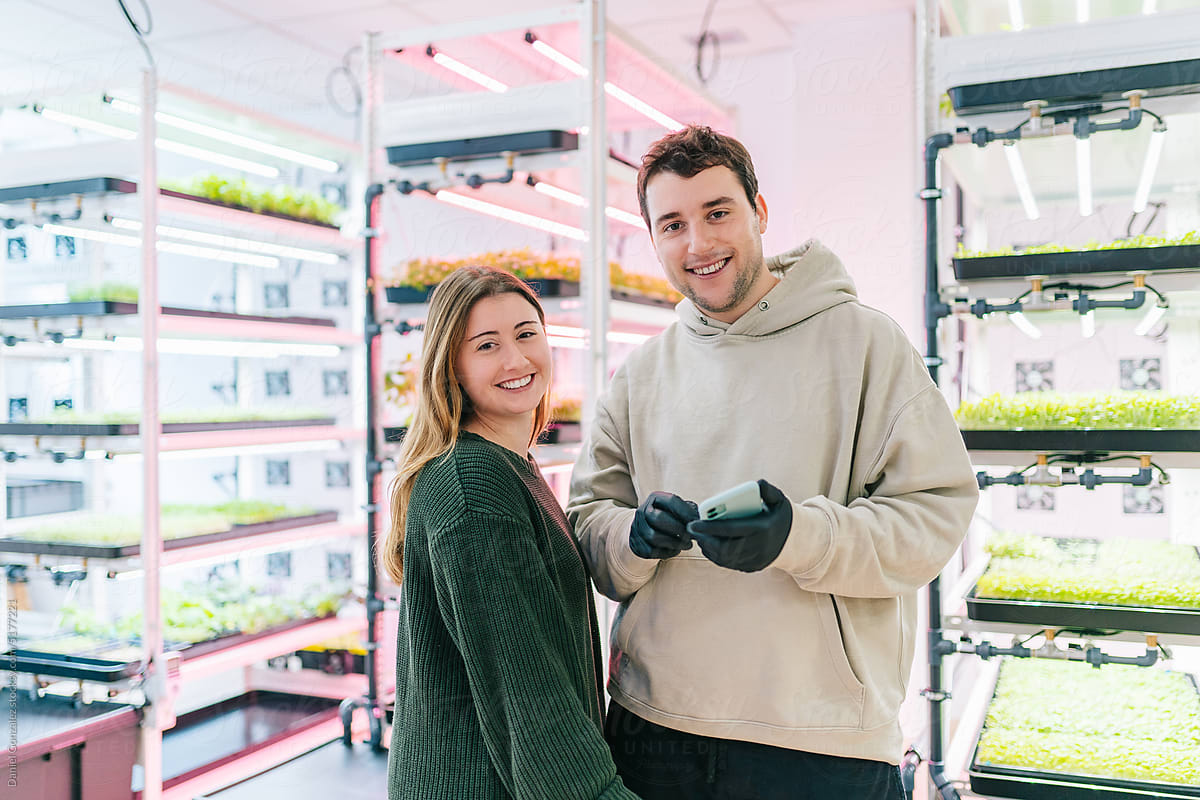 Cheerful couple standing in plant nursery