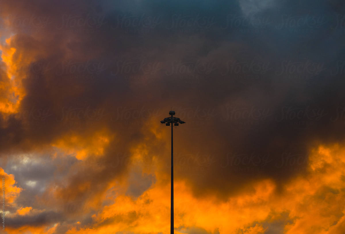 Minimalistic City Lamp Burning Sunset Clouds