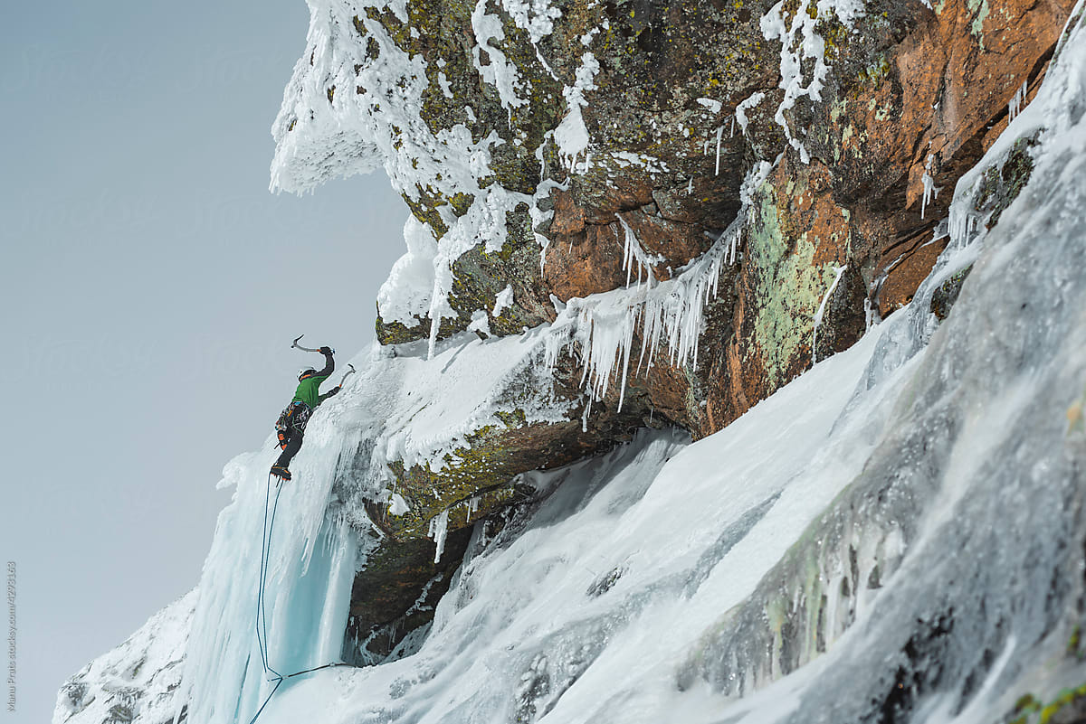 Ice Climbing On Frozen Waterfall