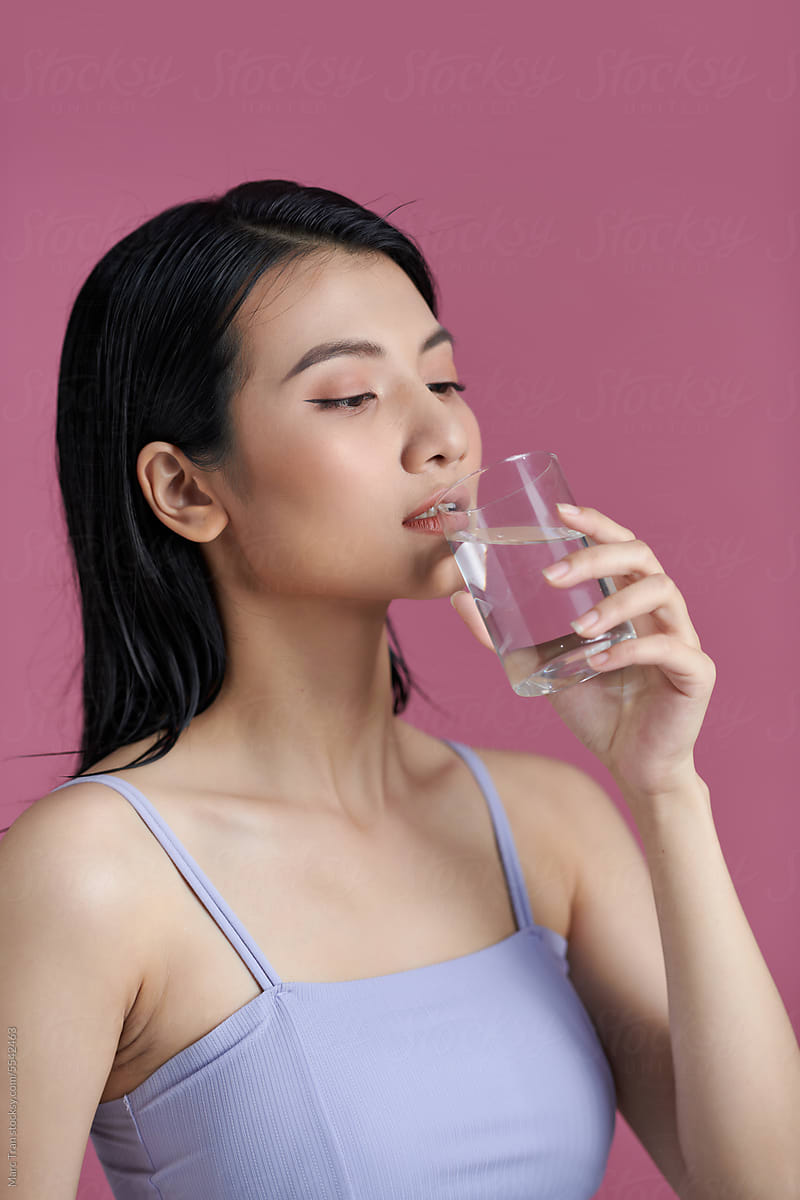 Smiling Young Woman with glass of Water