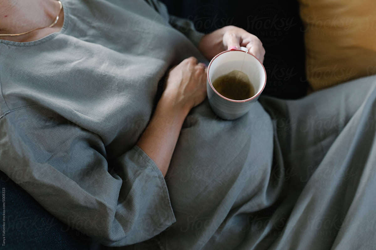 A pregnant woman with a cup of tea