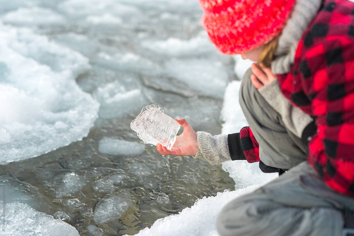Girl looks at piece of ice pulled from Ontario lake