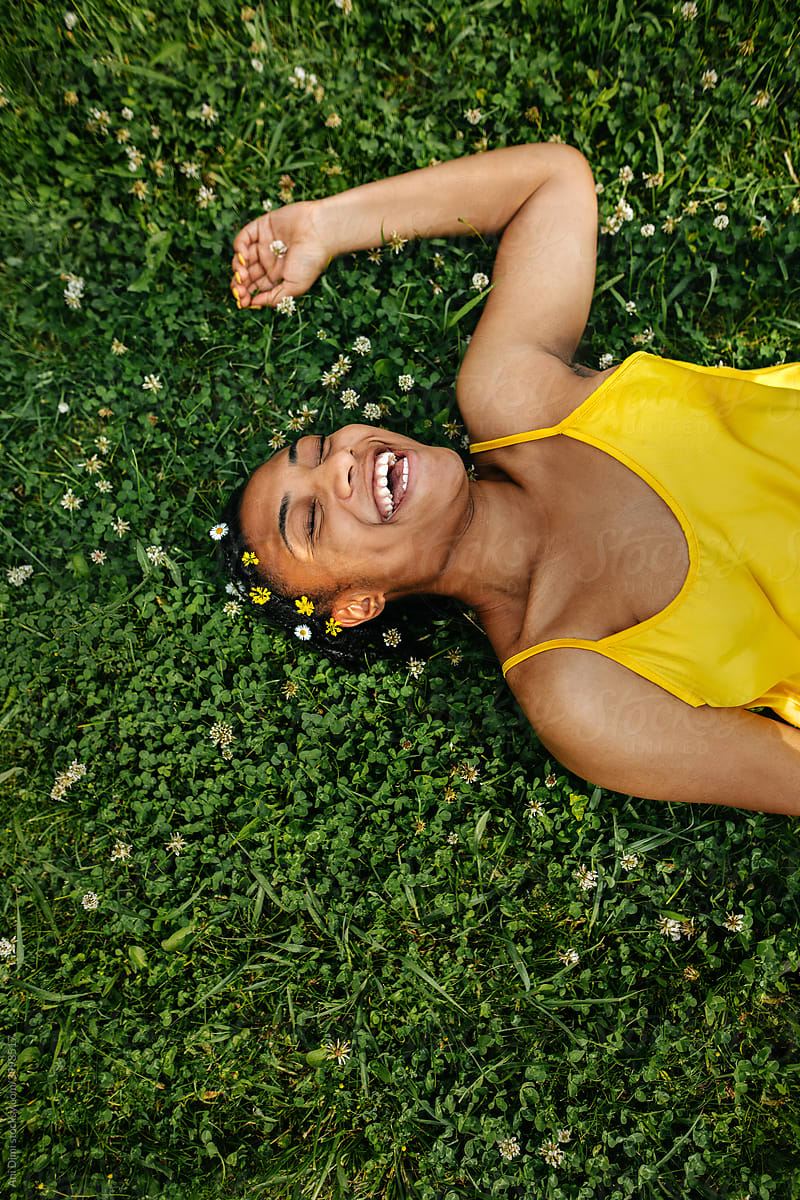 Black Woman Laying Down In The Grass By Stocksy Contributor Ani