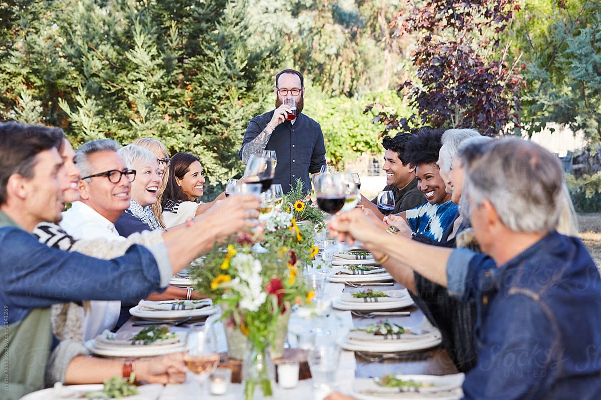 Friends giving a celebration toast at dinner party