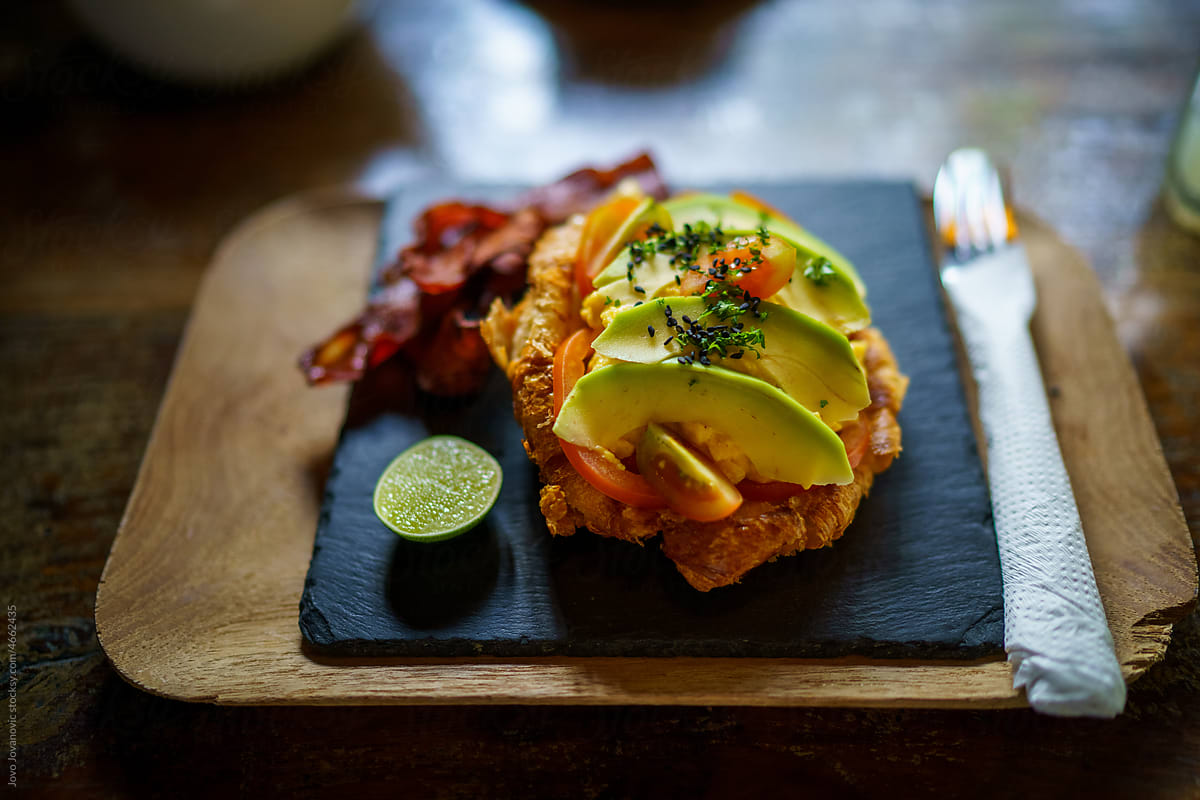 Healthy meal with avocado on slate serving board