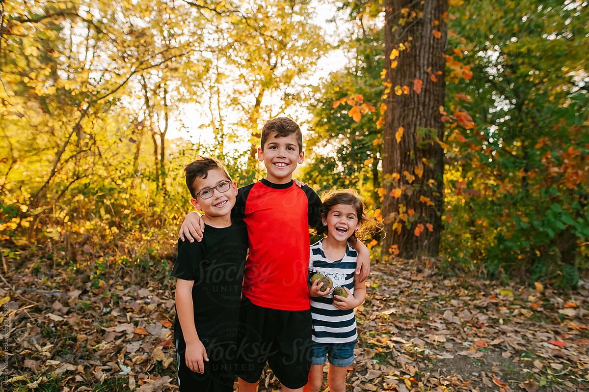 Three happy kids on an autumn day.