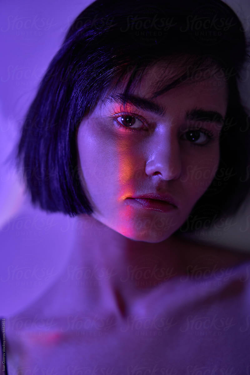 Female model with short hair under neon light