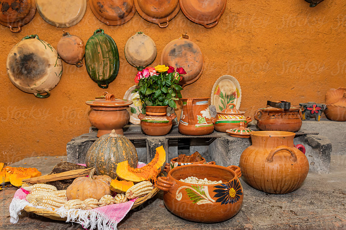 Clay pots hung on the wall in a traditional Mexican kitchen