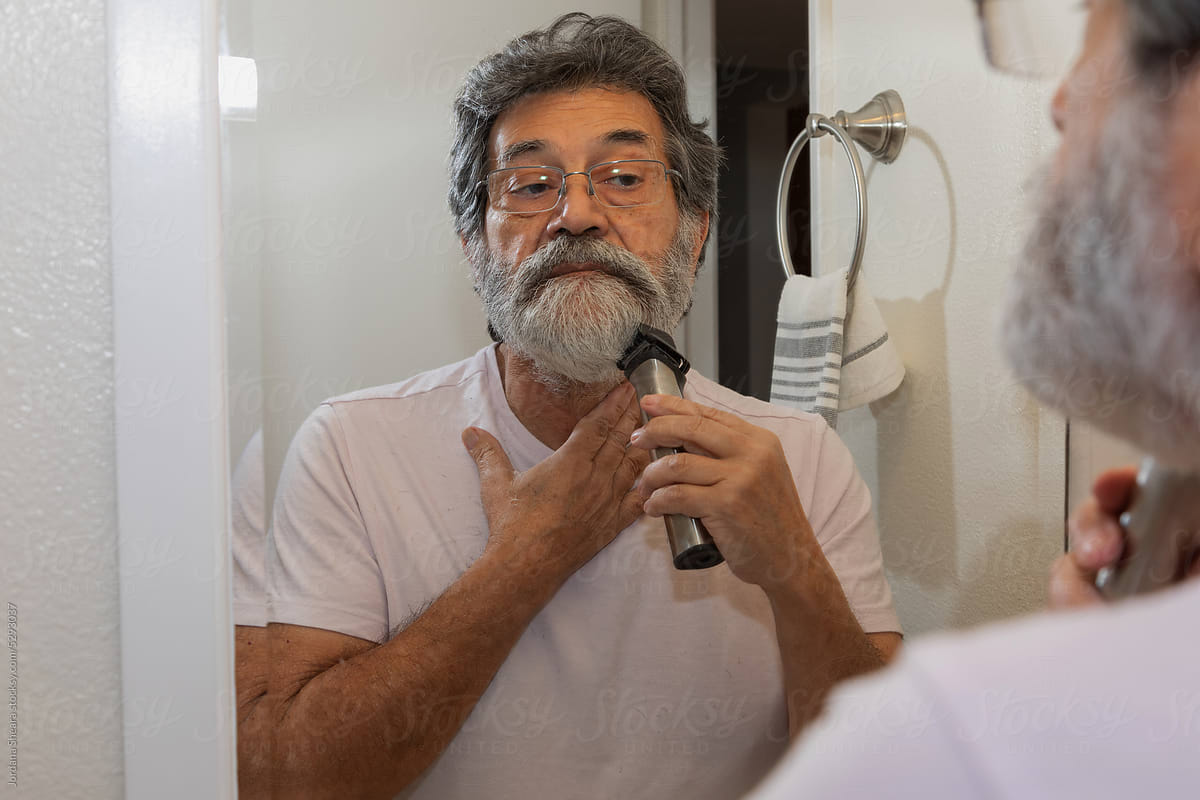 Man shaving his beard at home