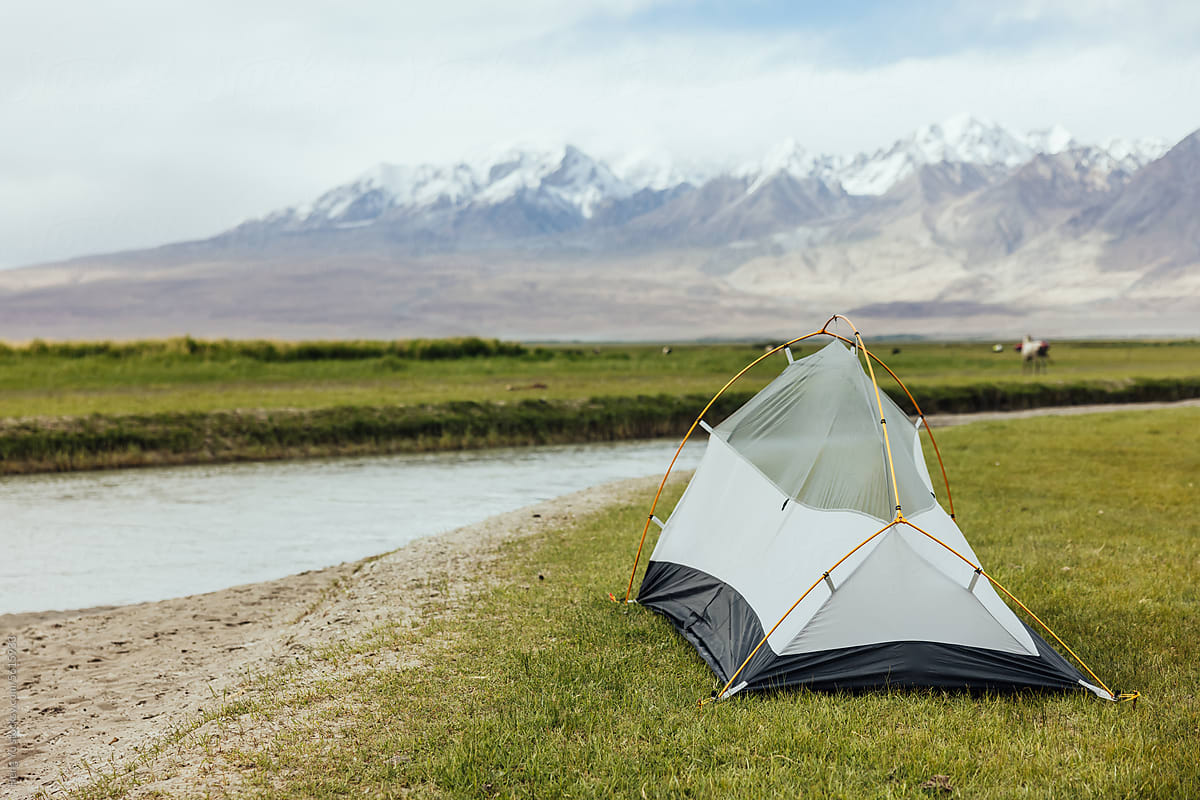 Riverside Camping with Snowy Mountain View