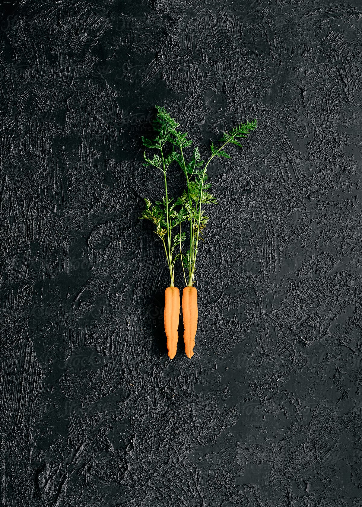 Two carrot halves on black