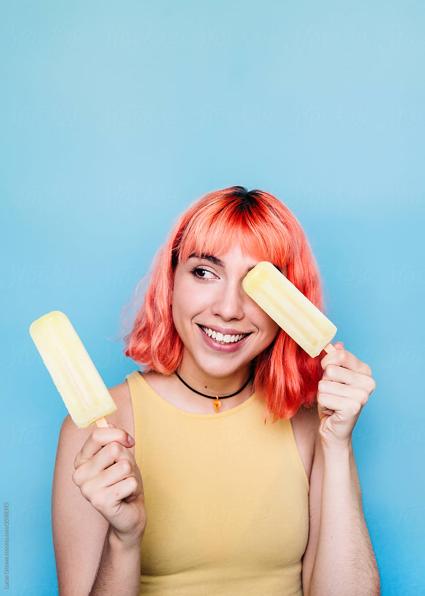 Young woman with lemon ice lollies