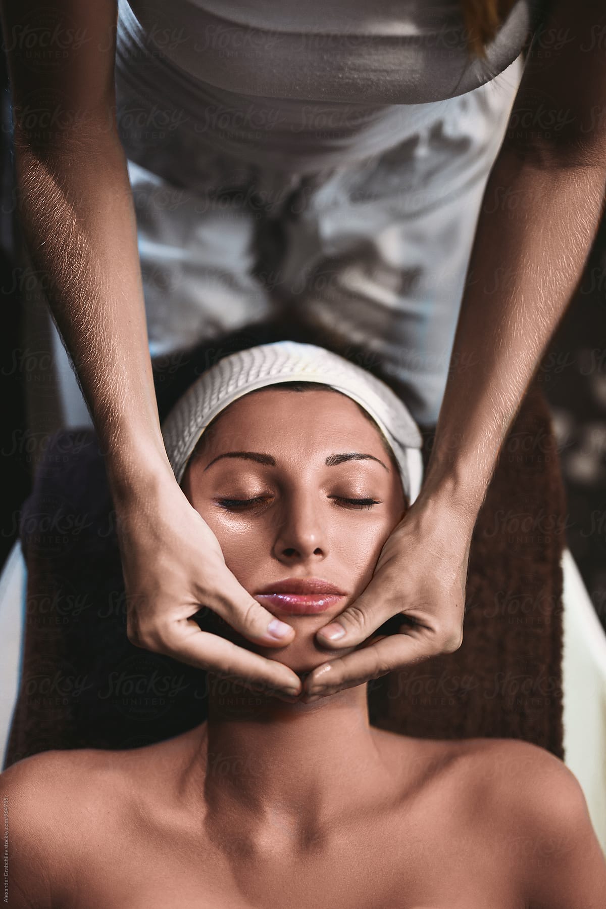 Face Care. Woman relaxing on massage table for facial spa treatment.